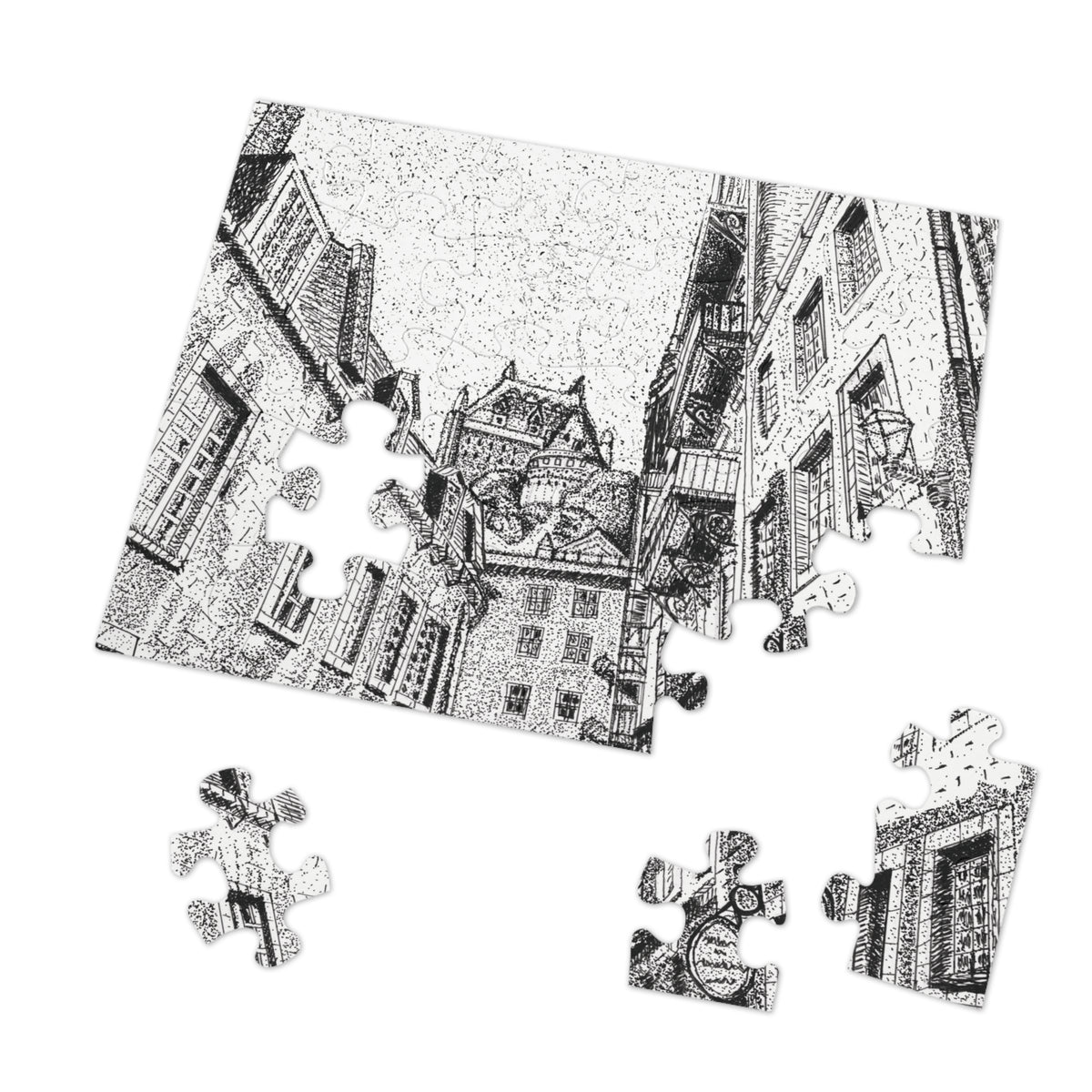 A black and white jigsaw puzzle showing a detailed architectural street scene with old buildings, displayed at an angle on a white background with several loose puzzle pieces scattered below.