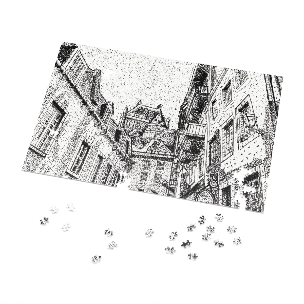 A black and white jigsaw puzzle showing a detailed architectural street scene with old buildings, displayed at an angle on a white background with several loose puzzle pieces scattered below.