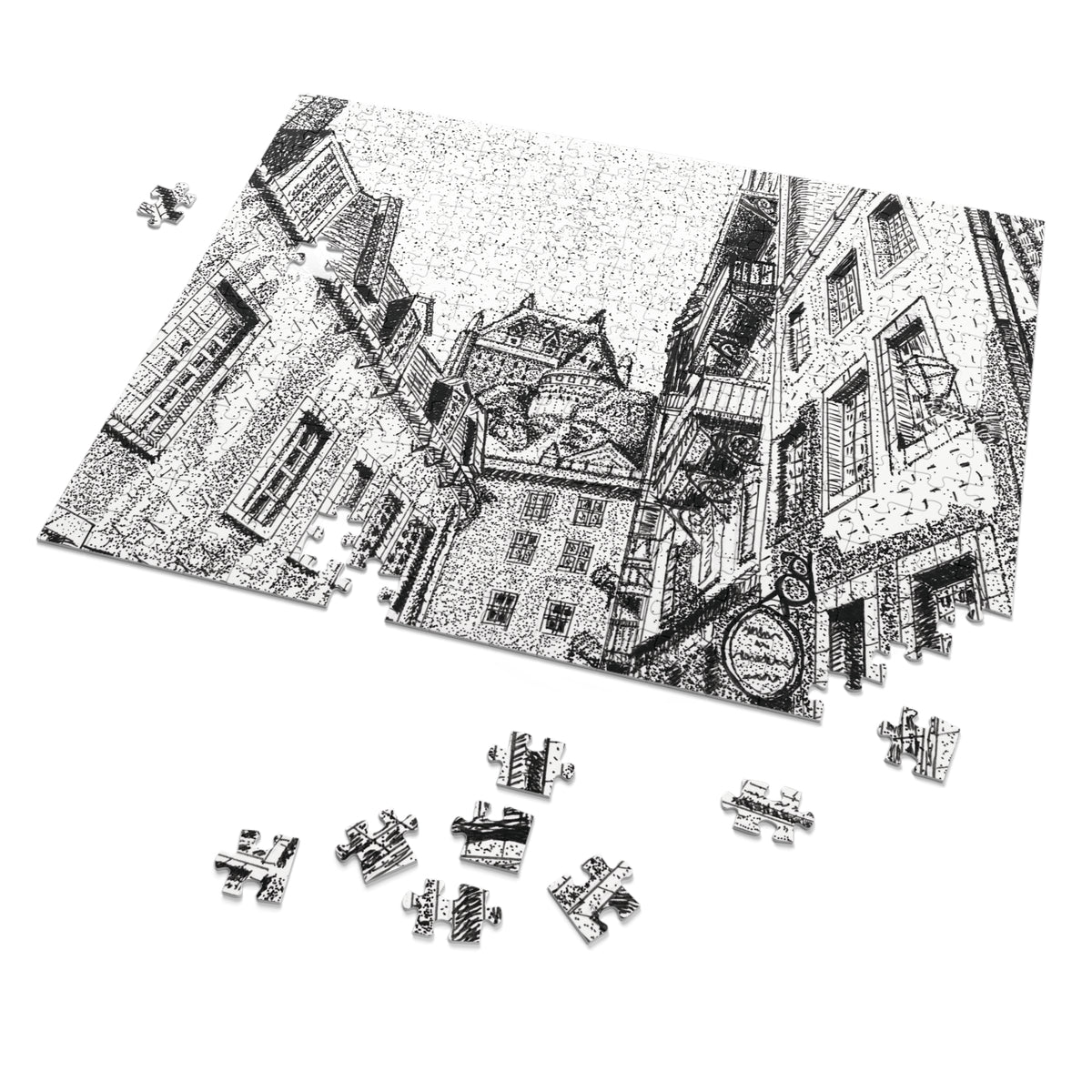 A black and white jigsaw puzzle depicting a detailed street scene with old buildings, shown partially assembled with several loose pieces scattered below on a white background.