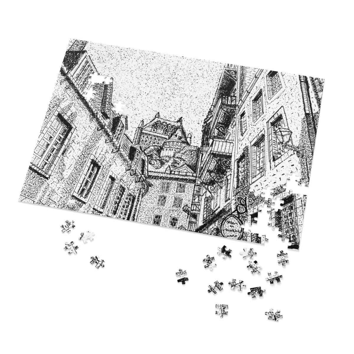 A black and white jigsaw puzzle showing a detailed architectural street scene with old buildings, displayed at an angle on a white background with several loose puzzle pieces scattered below.